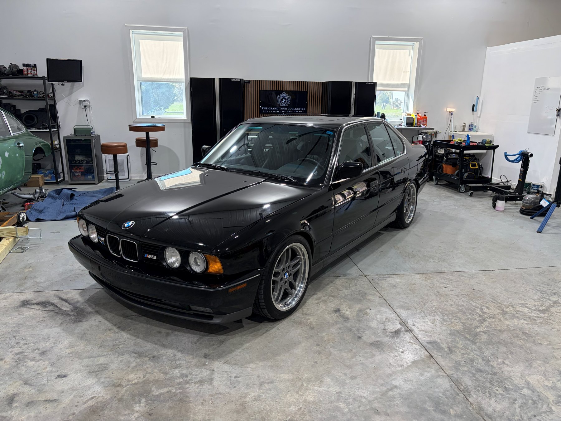 Black BMW M5 after paint polishing from the front left angle