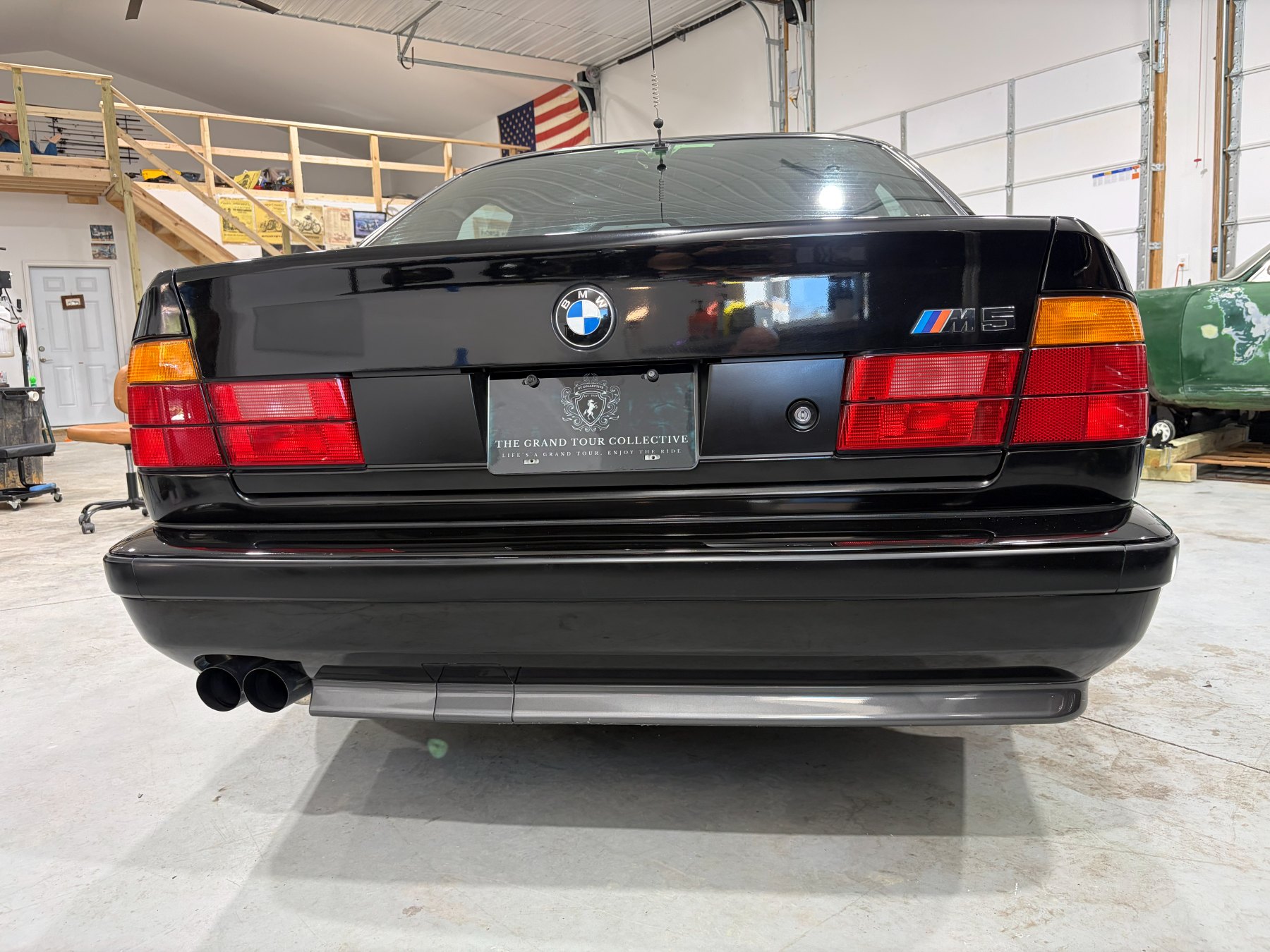 Black BMW M5 rear view after paint polishing