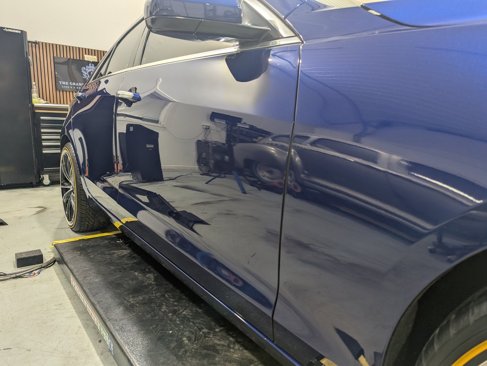After paint polishing blue Cadillac ATS side panel with improved reflection